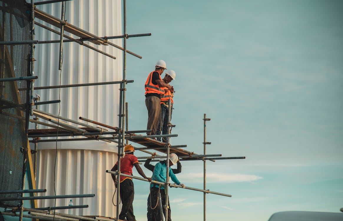 Scaffolding crew assembling structure on site